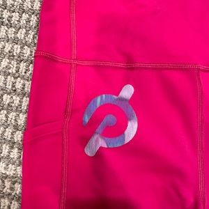 NWOT size medium Peloton Interactive pink leggings. Side and key pocket.